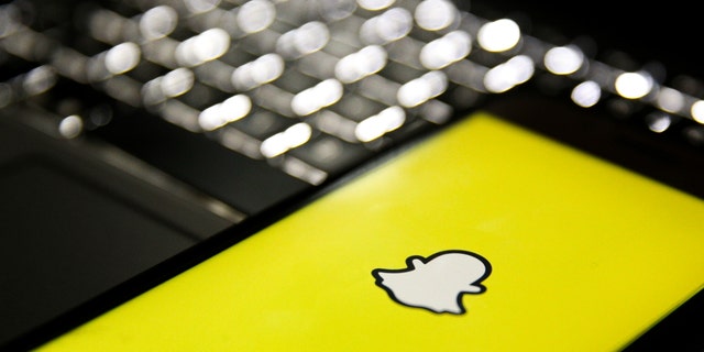 In this photo illustration, a mobile phone screen displays the Snapchat logo in front of a keyboard in Istanbul, Turkey, Feb. 24, 2020.