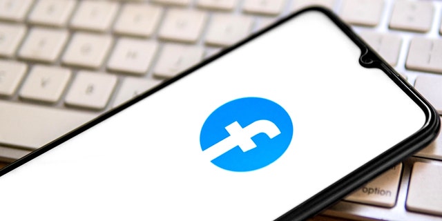 In this photo illustration, a Facebook logo is displayed on a smartphone.