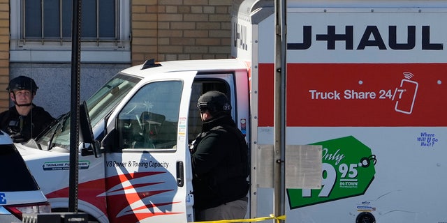 Members of the NYPD bomb squad examine a rental truck that was stopped and the driver arrested, Feb. 13, 2023, in Brooklyn, New York.
